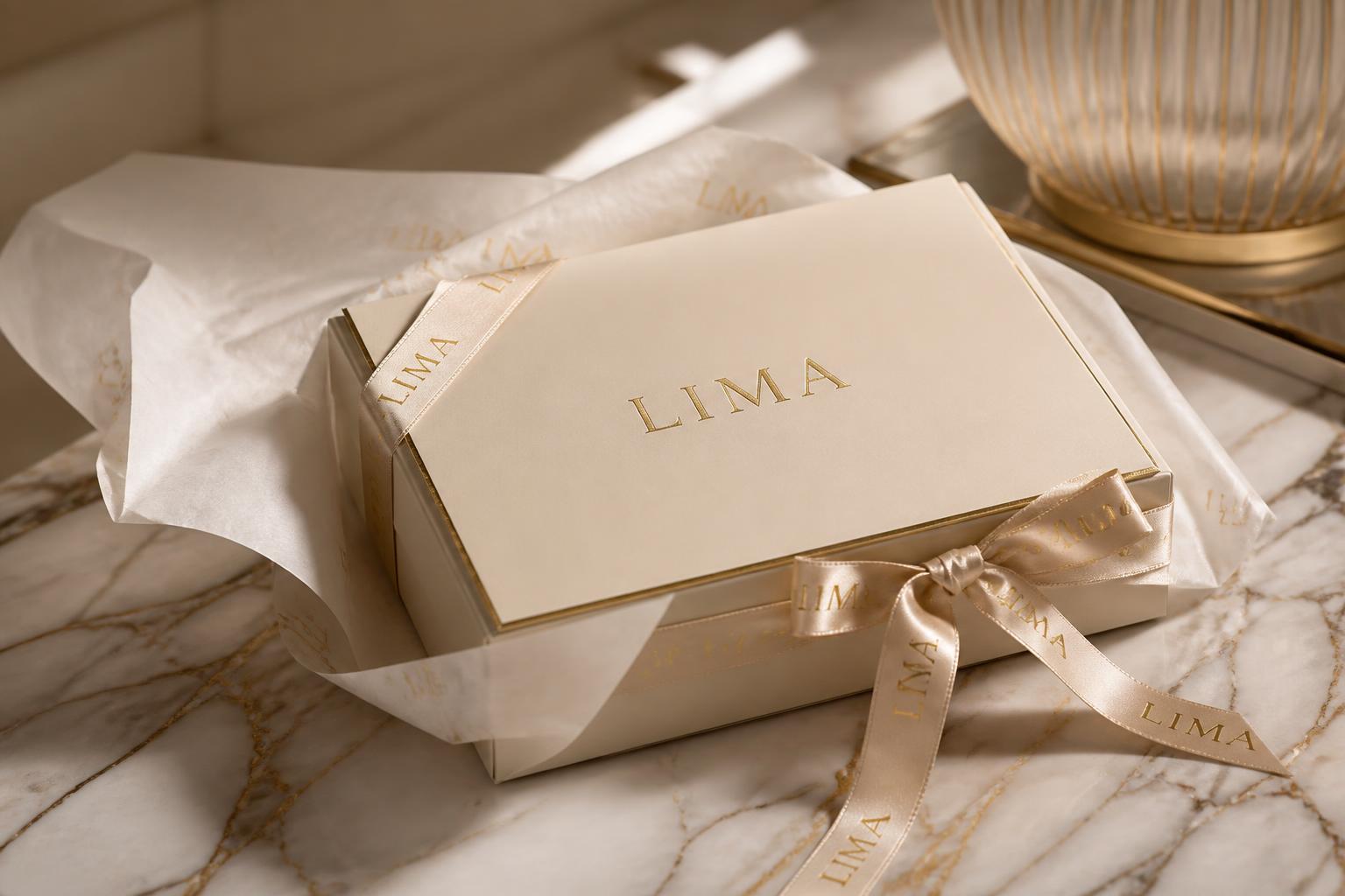 An elegant LIMA package wrapped in tissue and tied with a satin ribbon