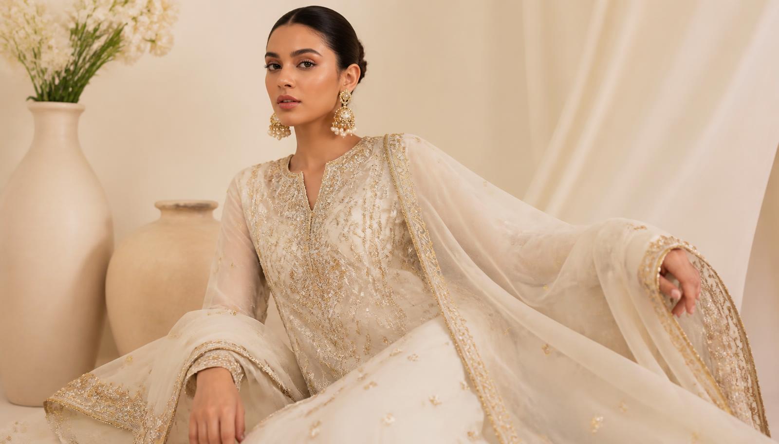Model in an ivory and gold hand-embroidered LIMA ensemble